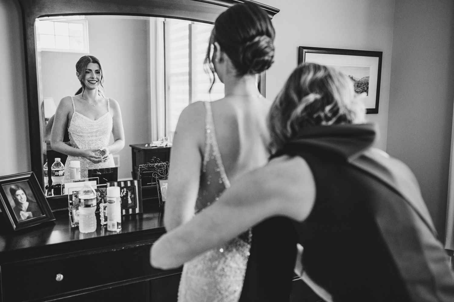 Black and white candid shots of wedding preparation moments in interior setting.