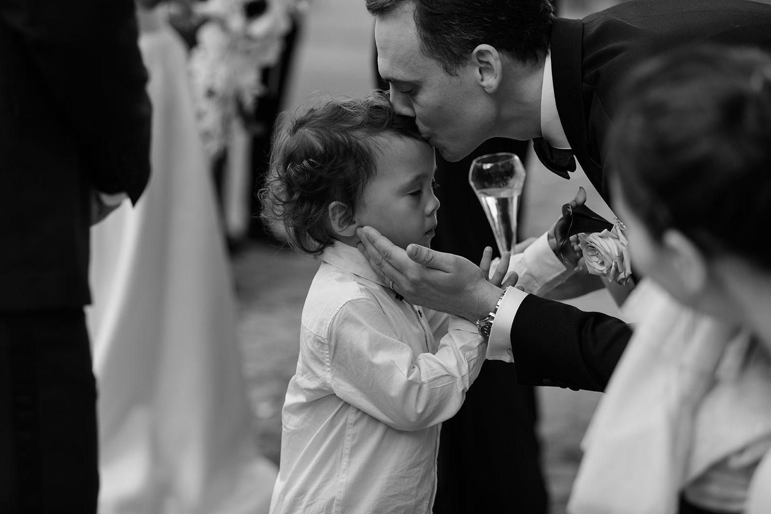 Black and white wedding photos showing intimate moments between couples during their special celebration.
