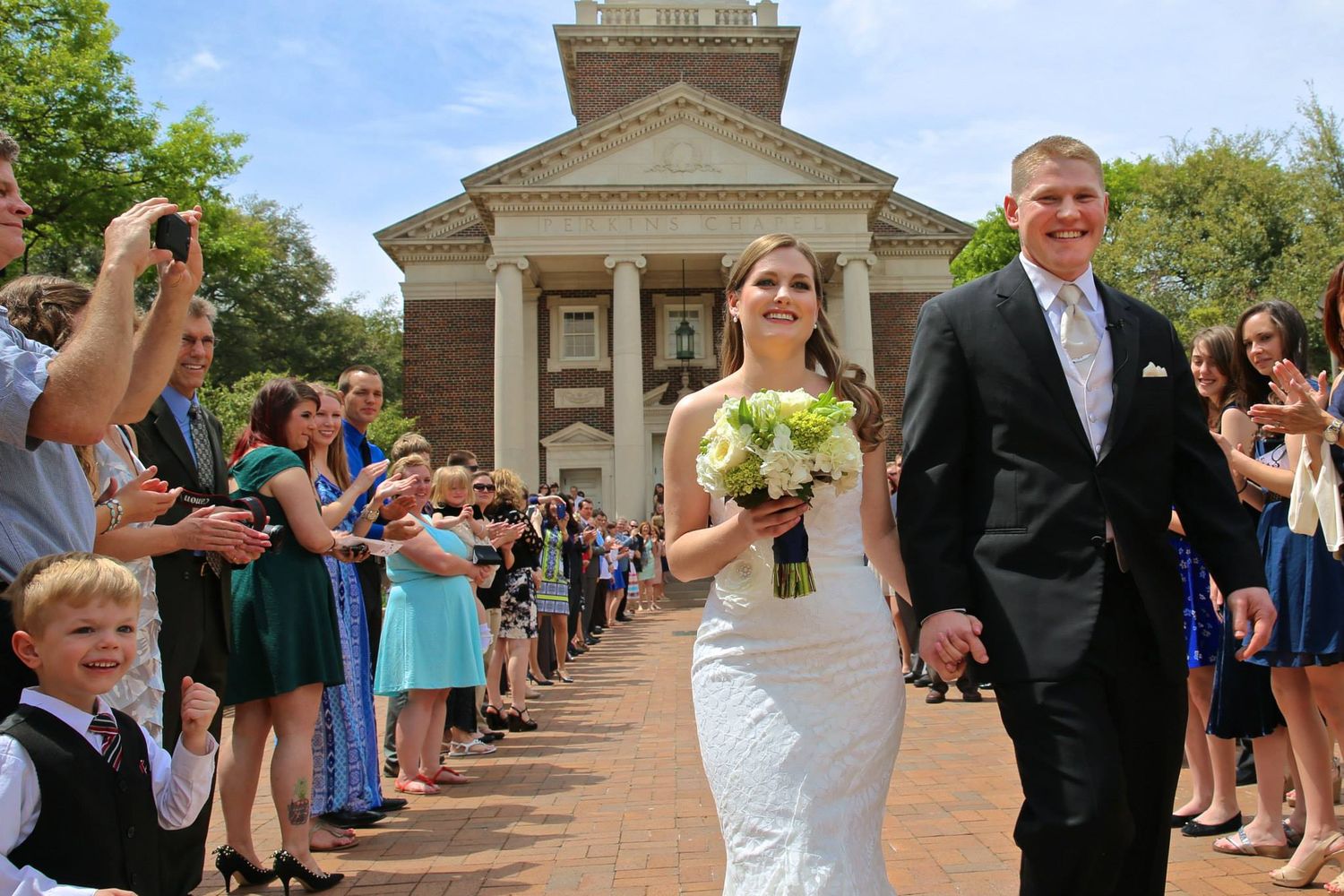 Wedding guests form a receiving line at Perkins Chapel at the SMU campus.  Perkins is a top wedding venue in Dallas, Tx.
