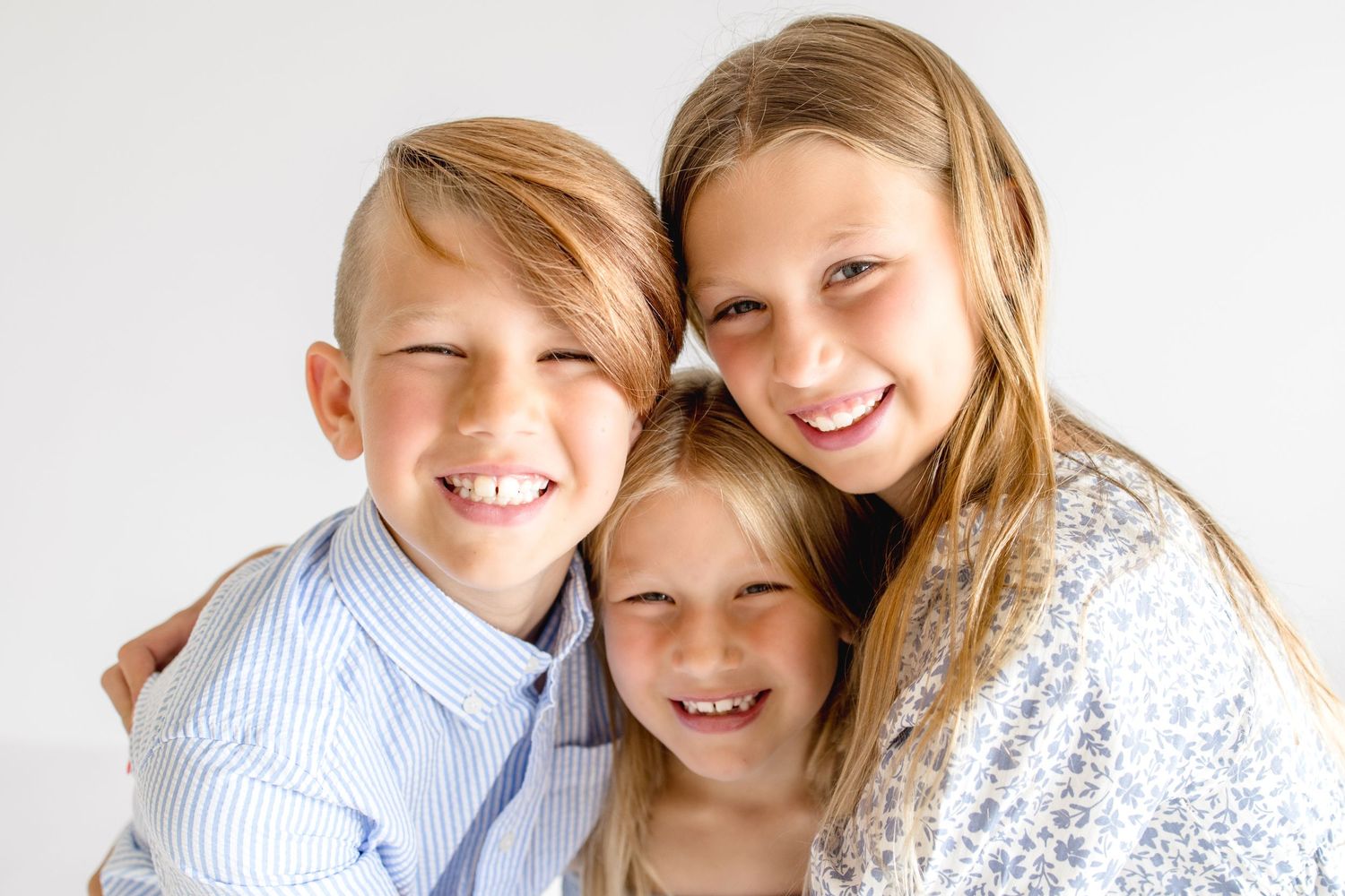 Candid lifestyle portrait session showing joyful interaction against clean white background.