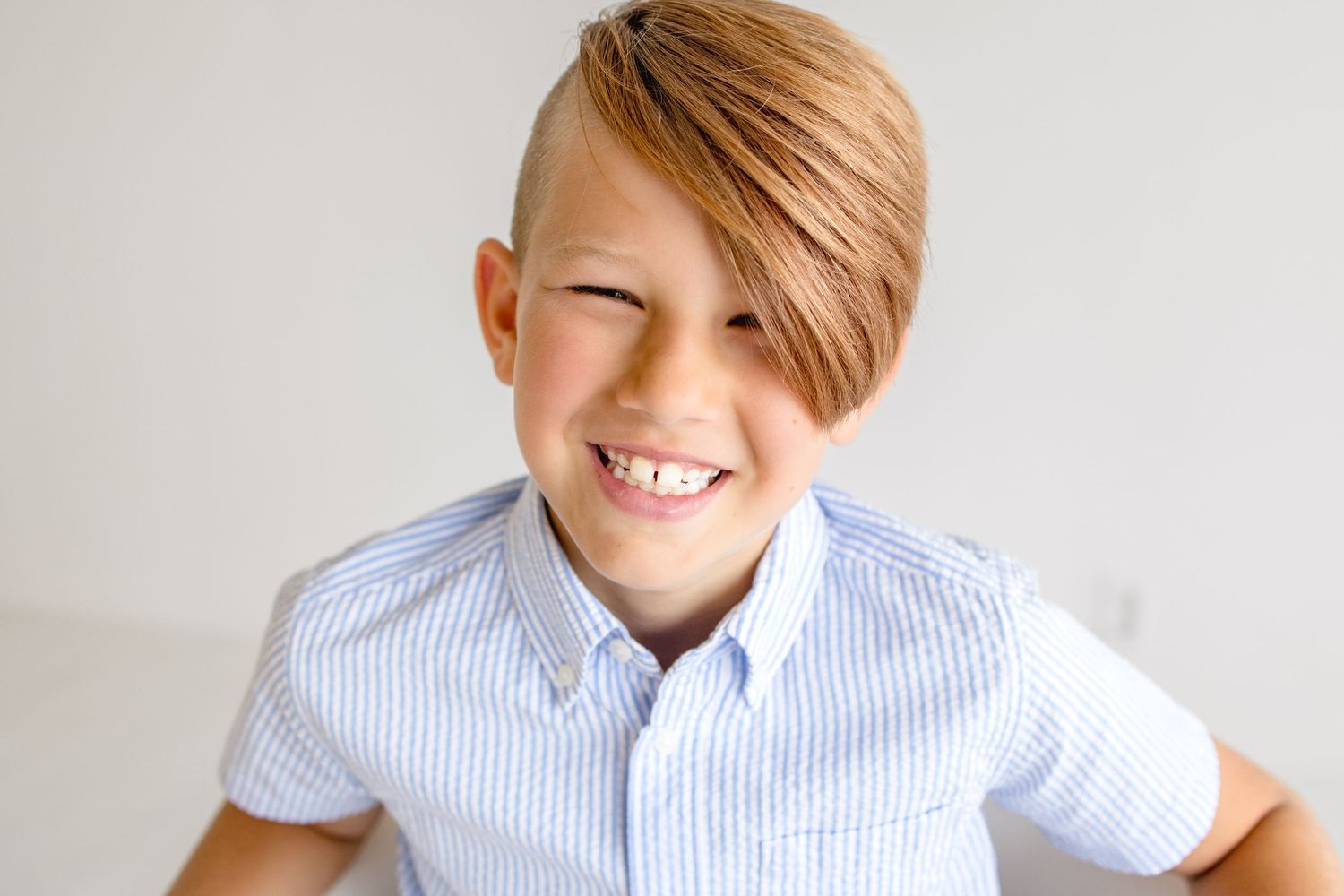 Close-up portrait series showing natural expressions in light blue collared shirt.