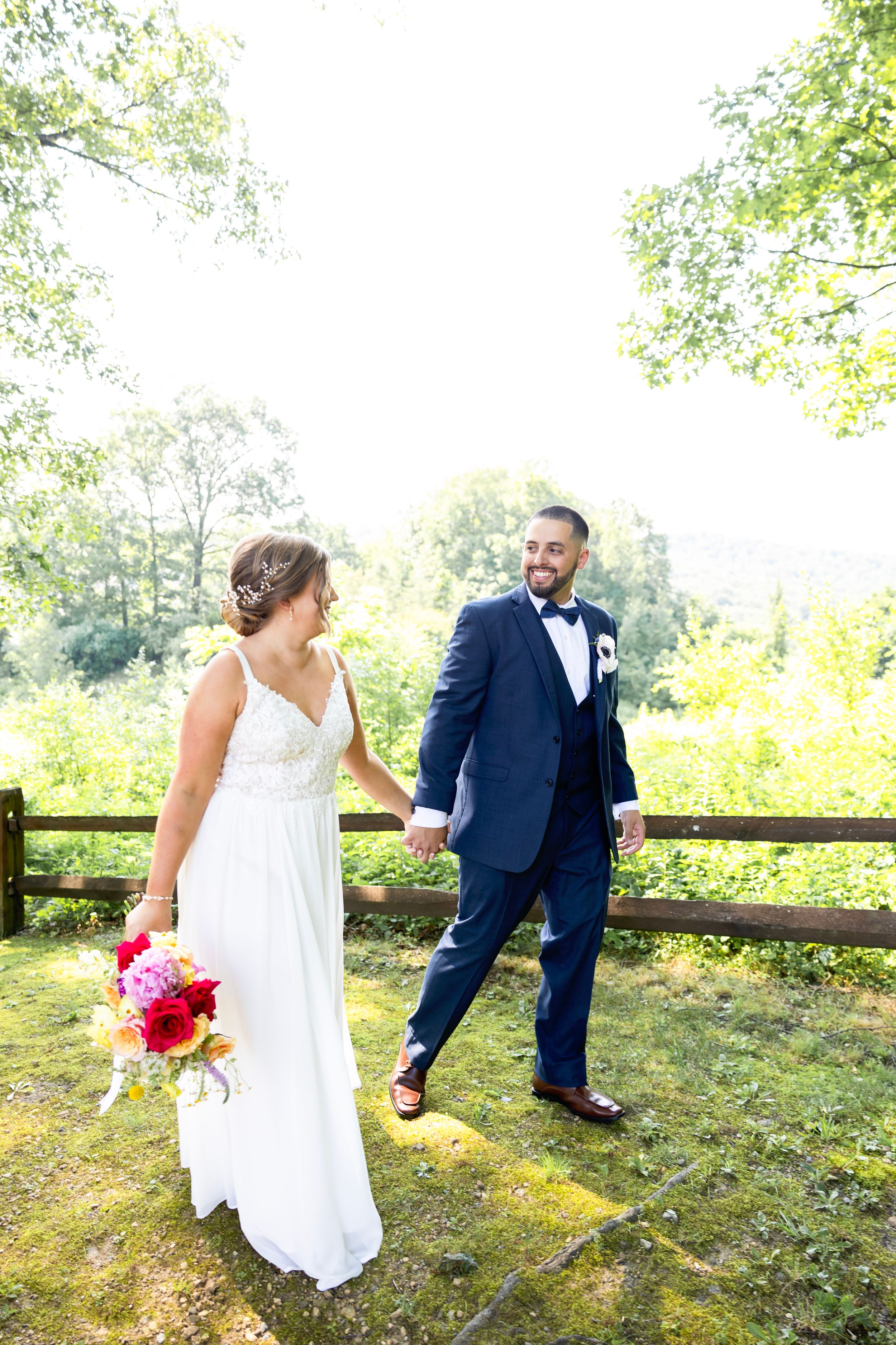 A couple in wedding attire stands by a rustic wooden fence | NJ wedding photographer | best NJ wedding photographer
