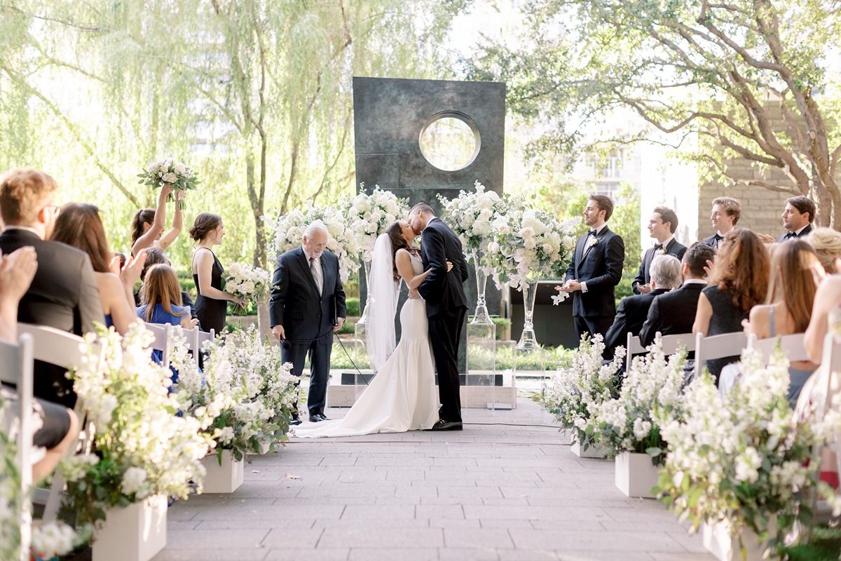 Couple kisses during their ceremony at the Nasher Sculpture Center, a Dallas wedding venue