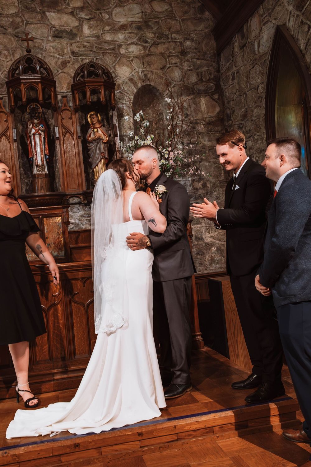 Bride and groom kiss after signing marriage license