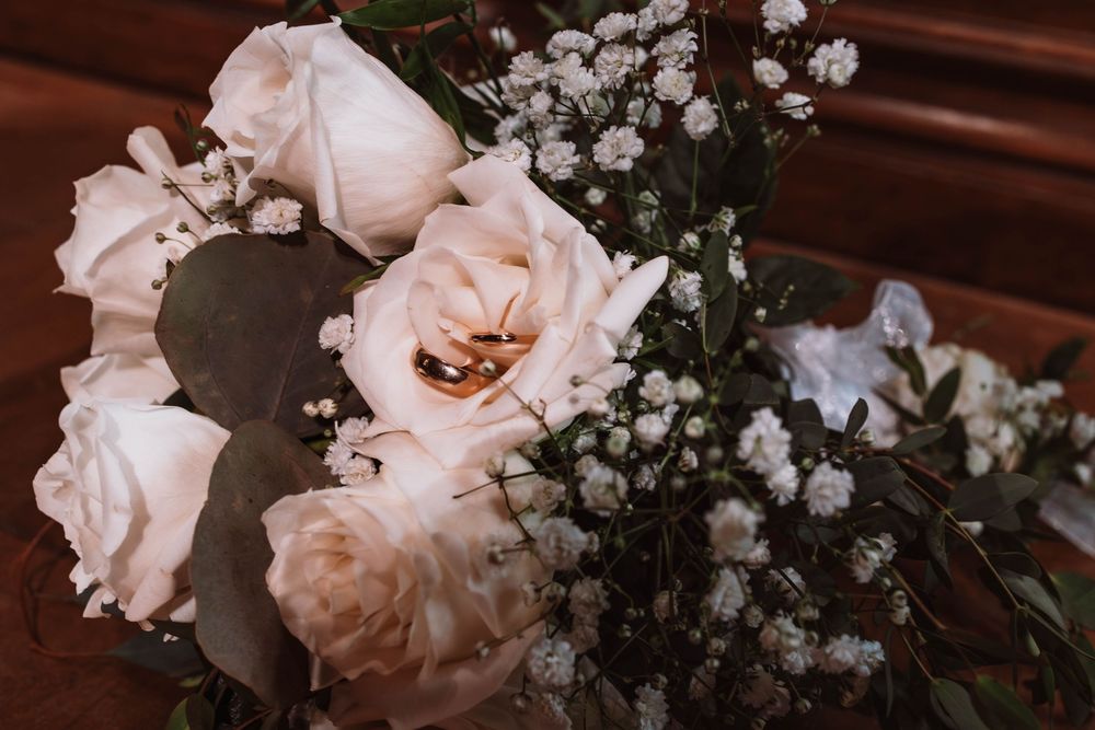 Close up of wedding rings and floral bouquet at hudson valley wedding