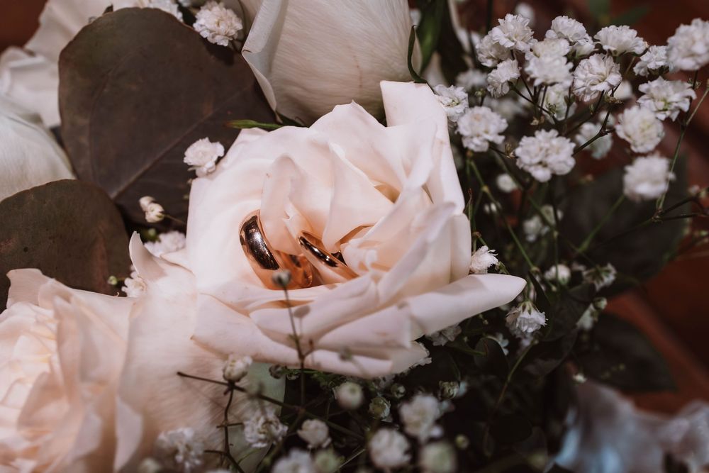 Close up of wedding rings and floral bouquet at hudson valley wedding