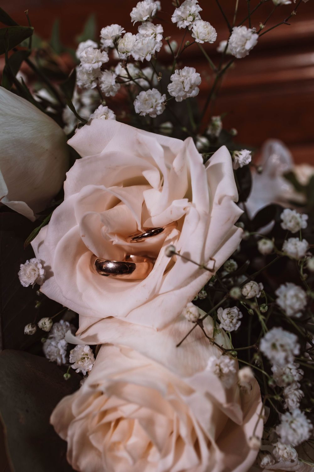 Close up of wedding rings and floral bouquet at Upstate NY 4wedding