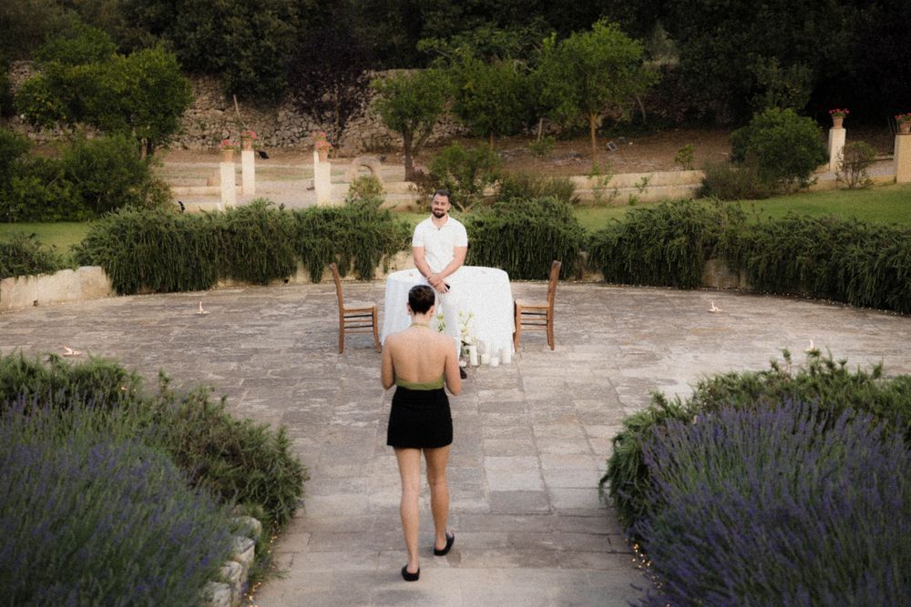 A curving garden path flanked by blooming purple lavender bushes leads through a tranquil landscape.