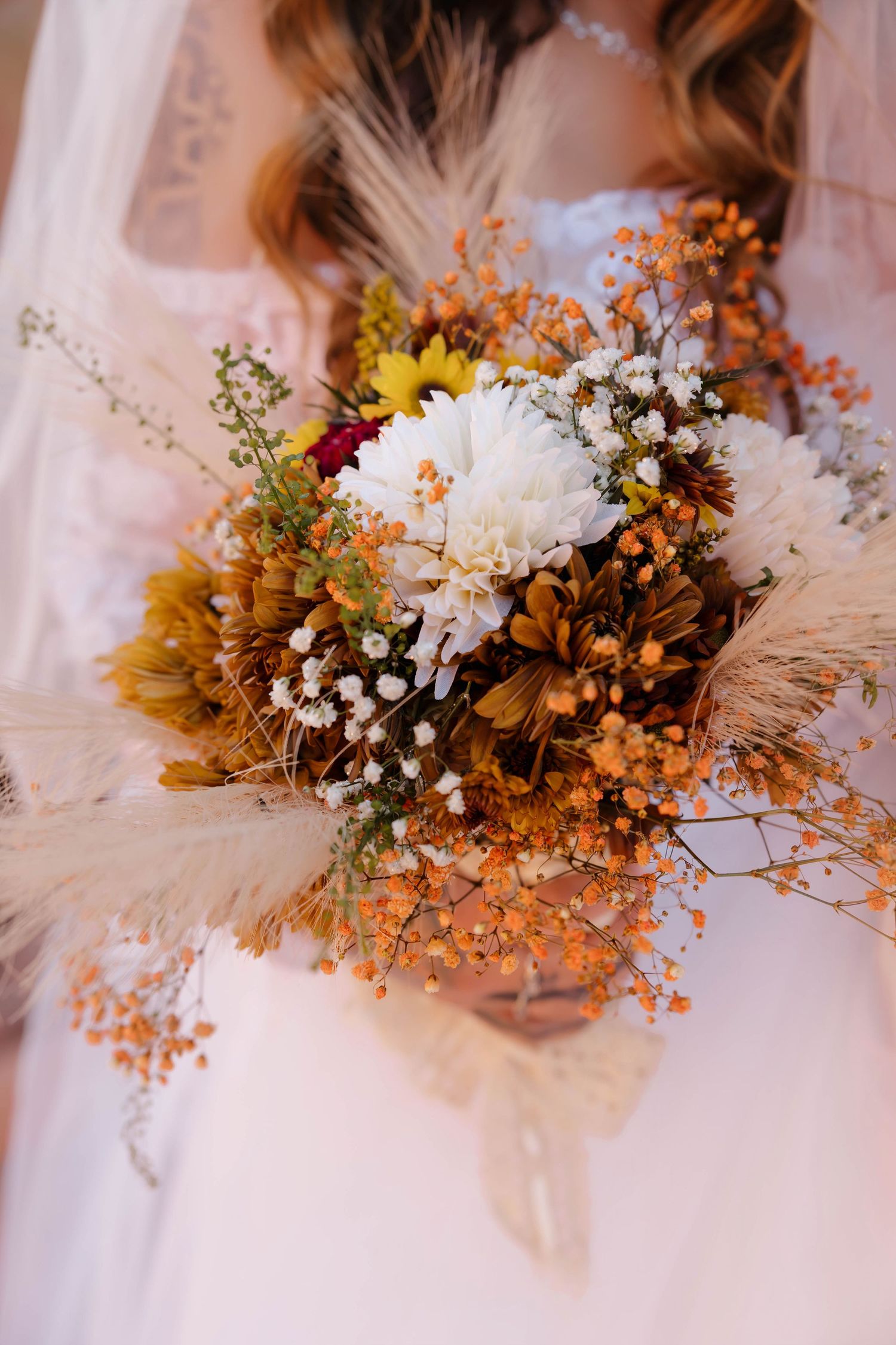A series of dried flower bouquets featuring white baby's breath and autumn-colored florals arranged against a white backdrop.