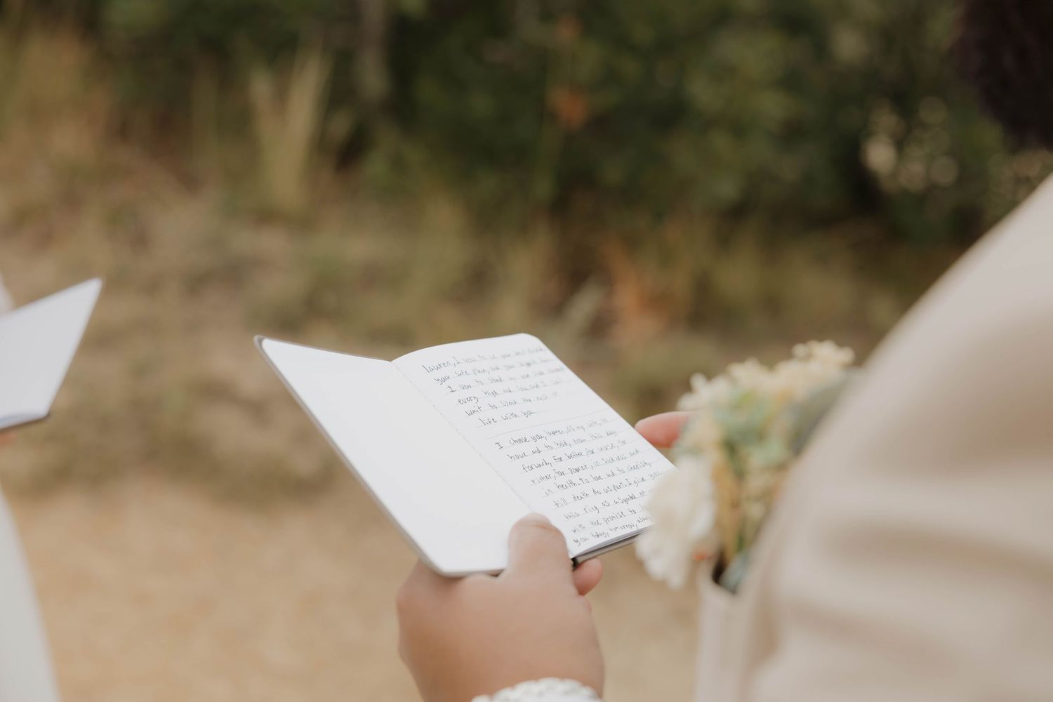 White paper sheets scattered in the air against a blurred outdoor background creating a dreamy atmosphere.