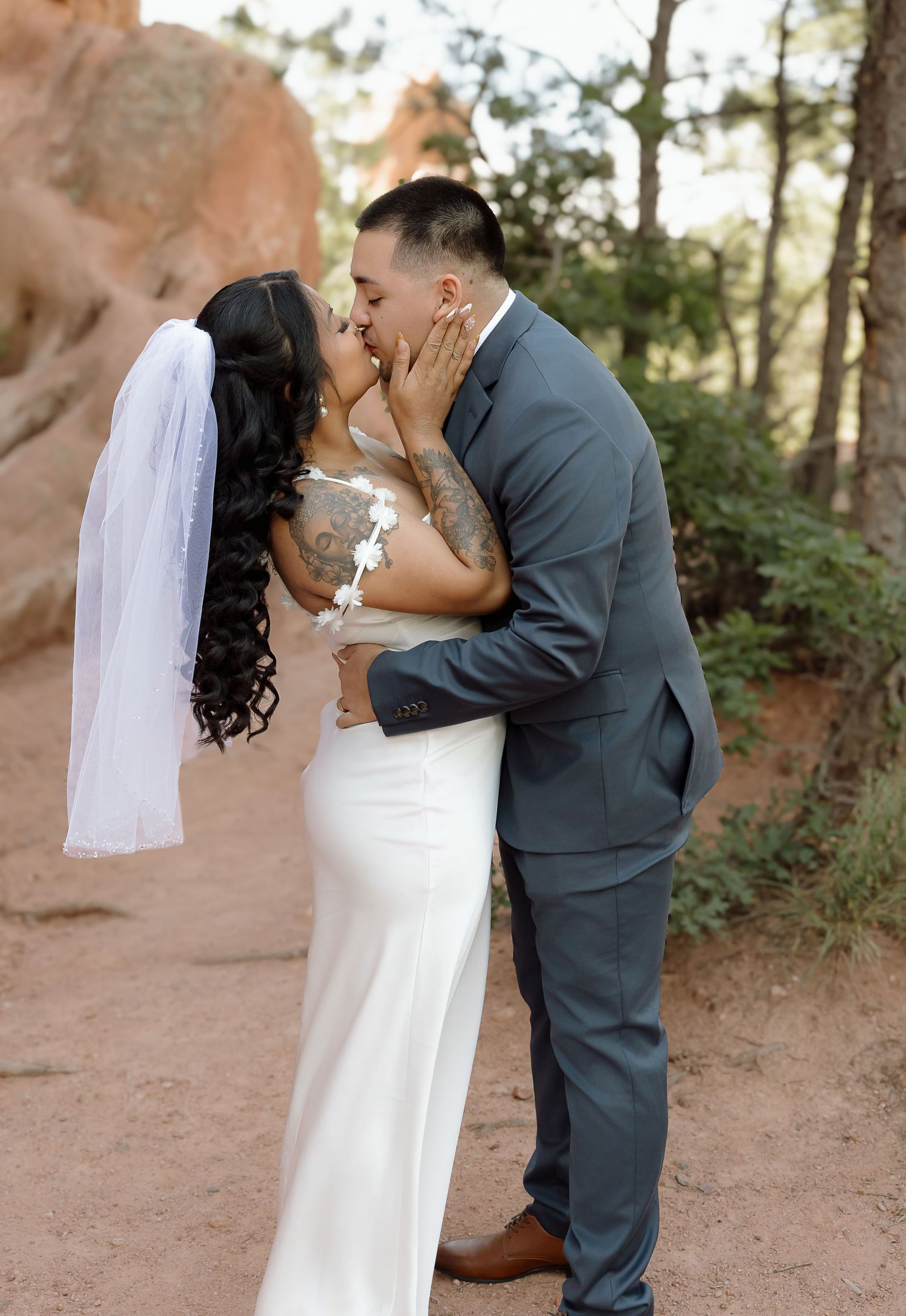 A romantic wedding photo sequence captured against a desert landscape backdrop with natural lighting.