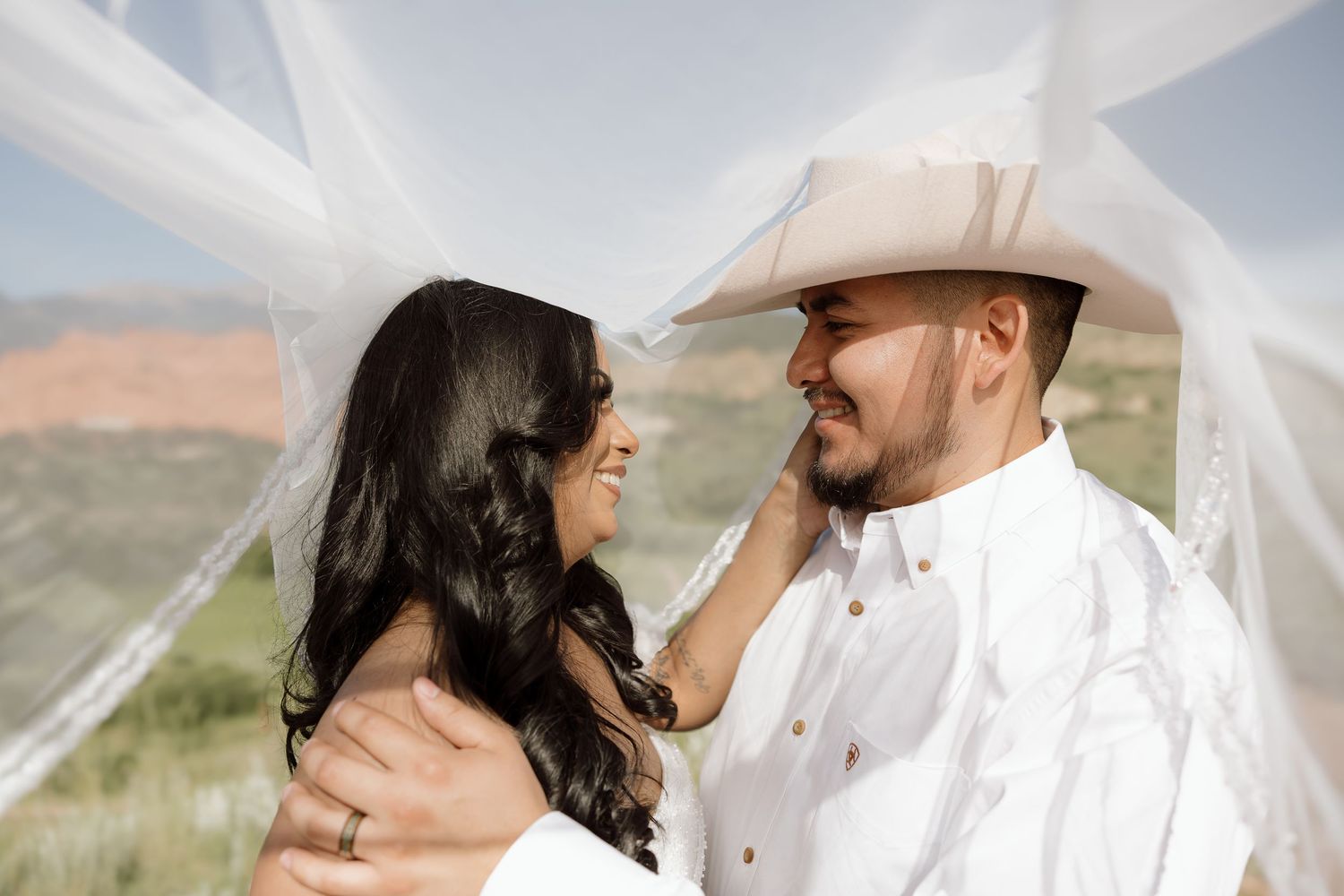 A romantic couple in western attire poses together in various intimate shots against an outdoor backdrop.