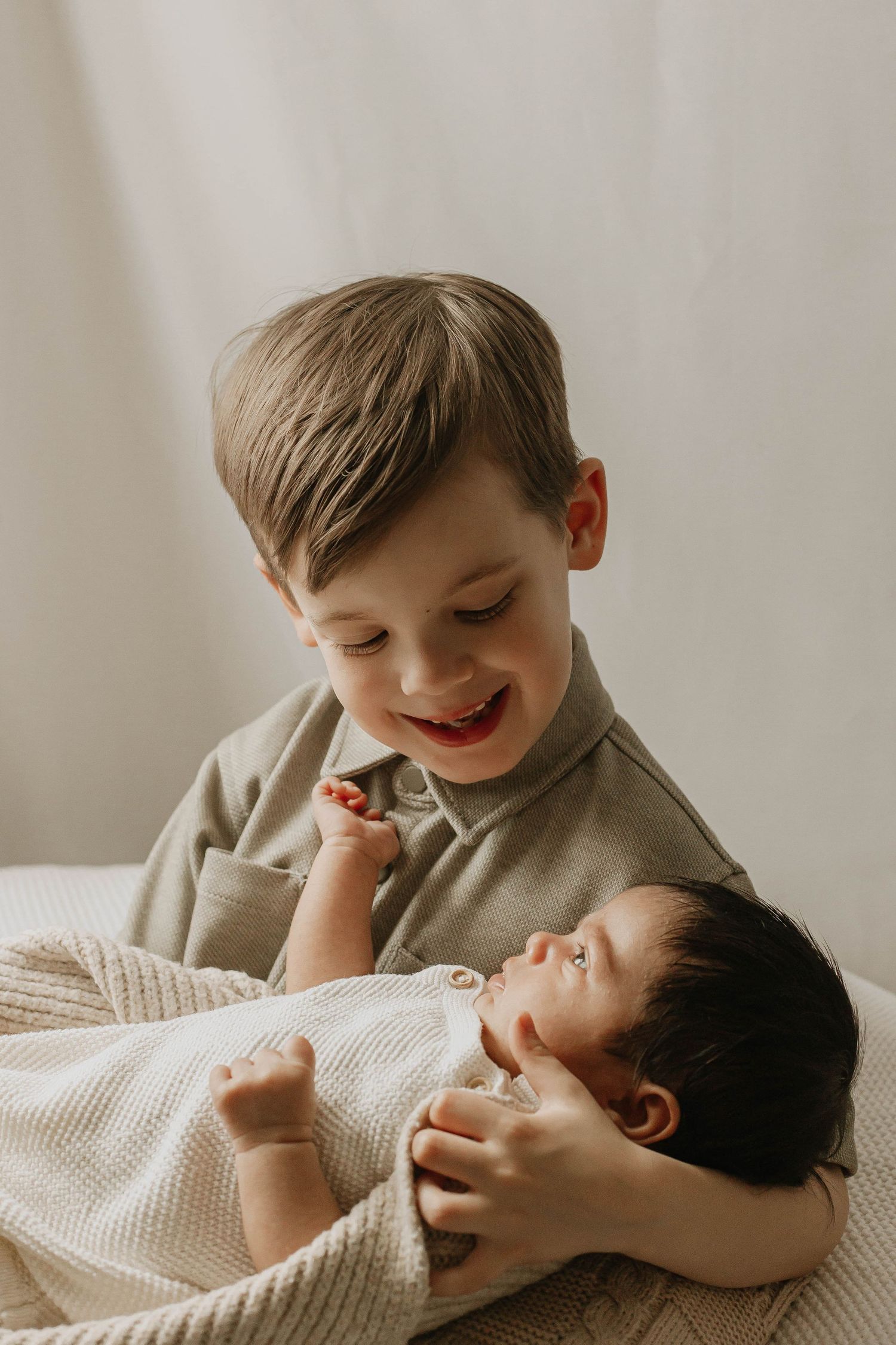 Newborn in home session in Maidstone Kent. Older newborn at 8 weeks old. Photographed with older brother.