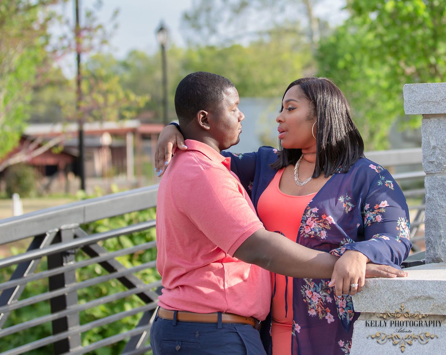 Couple in casual attire sharing an intimate moment on an outdoor deck.