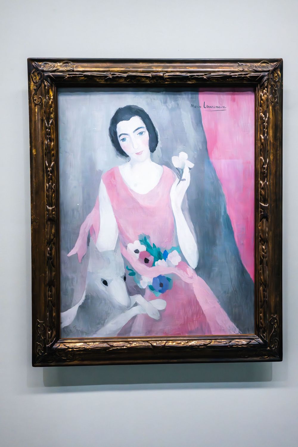 A sequence showing an abstract painting in a gold frame with pink and blue tones depicting a figure in a graceful pose.