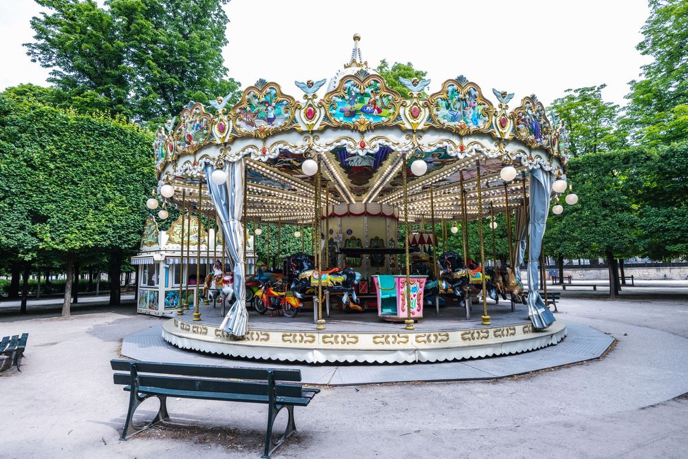 A collection of scenic photos showing a carousel, park benches, and walkways in a peaceful city park setting during daytime.