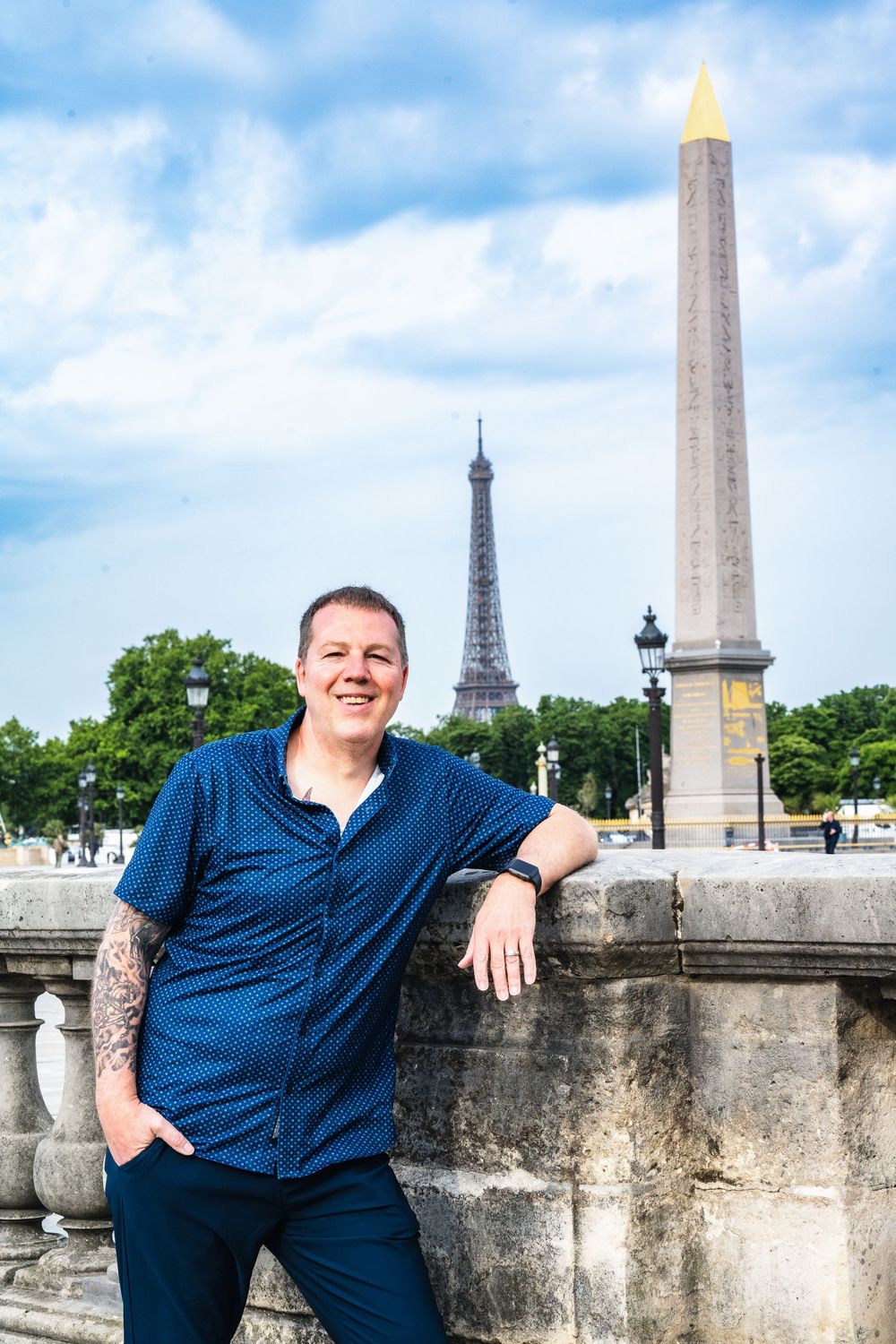 View of the Place de la Concorde obelisk and Eiffel Tower across from the cityscape in Paris, France.