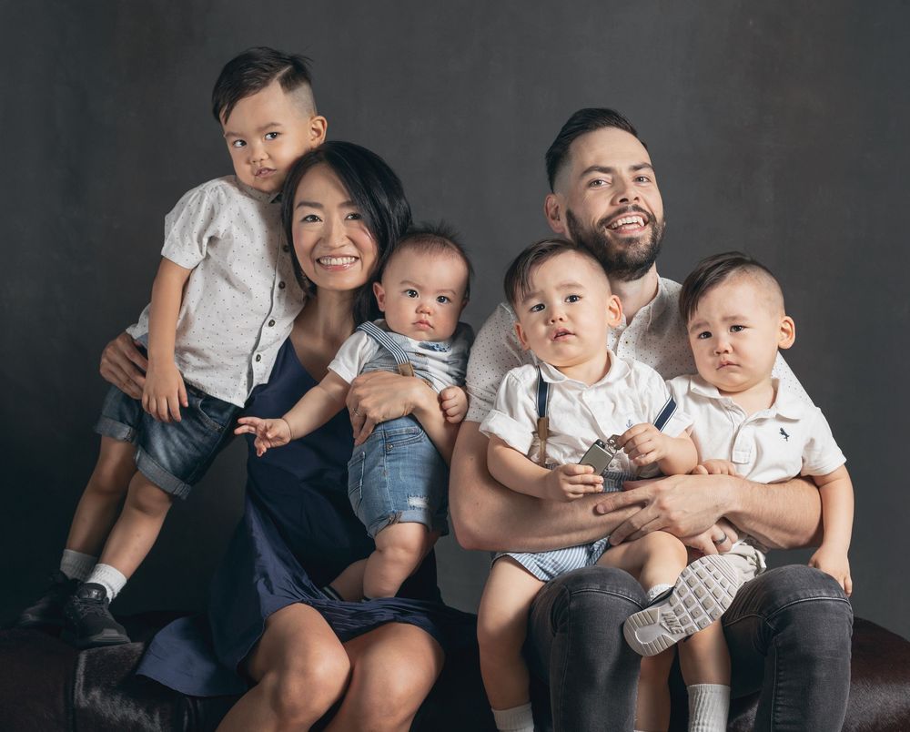 A set of candid black and white family portraits showing joyful moments and connections between loved ones.
