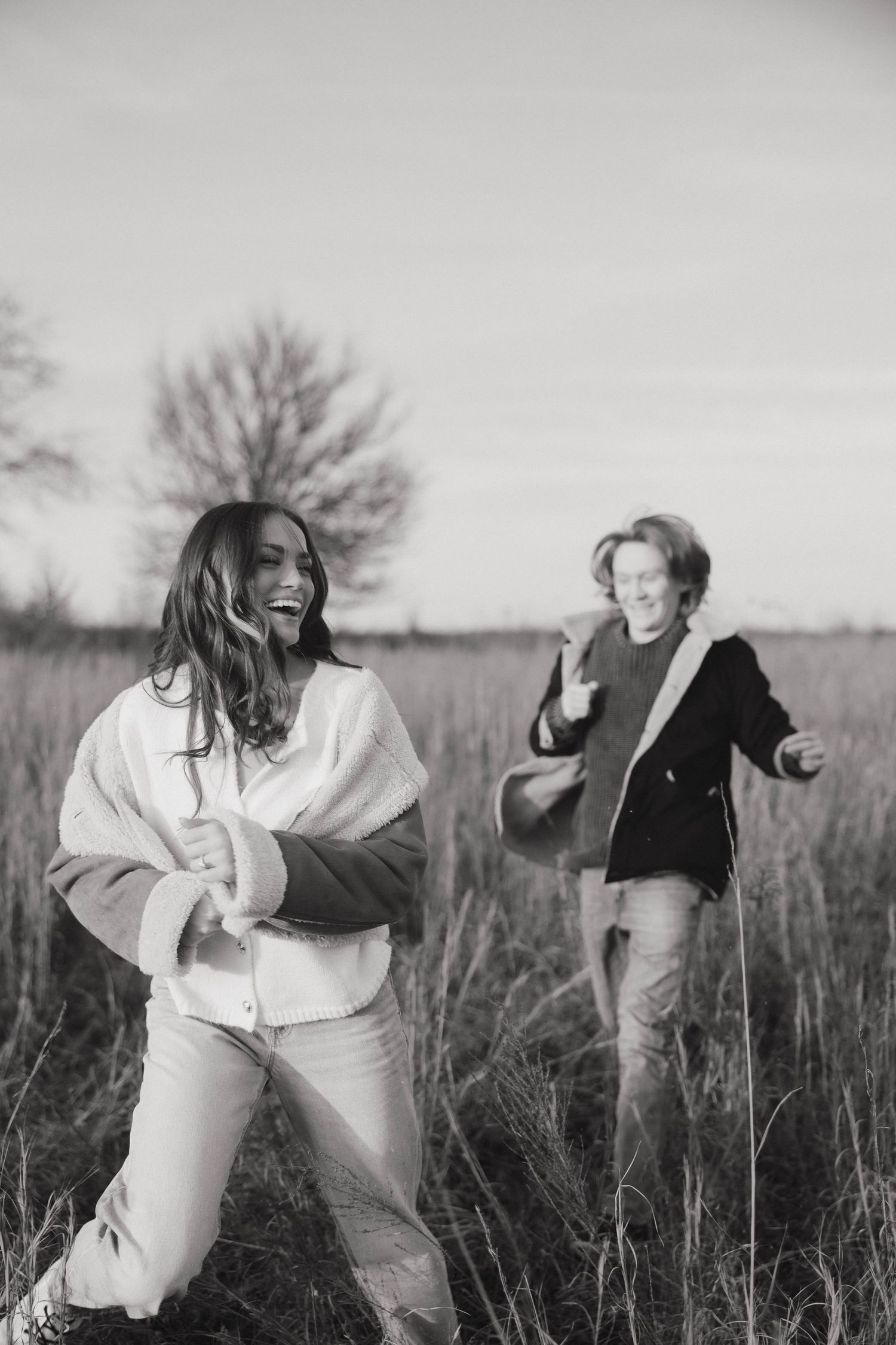 A sequence of black and white photos showing playful movement in a grassy field.