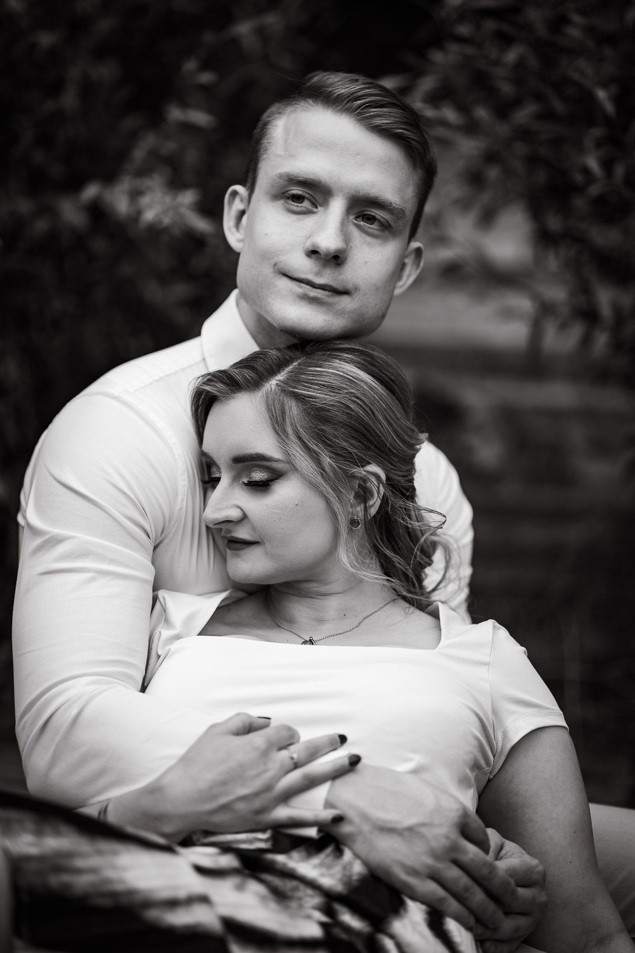 Black and white portrait series capturing tender embraces between a couple.