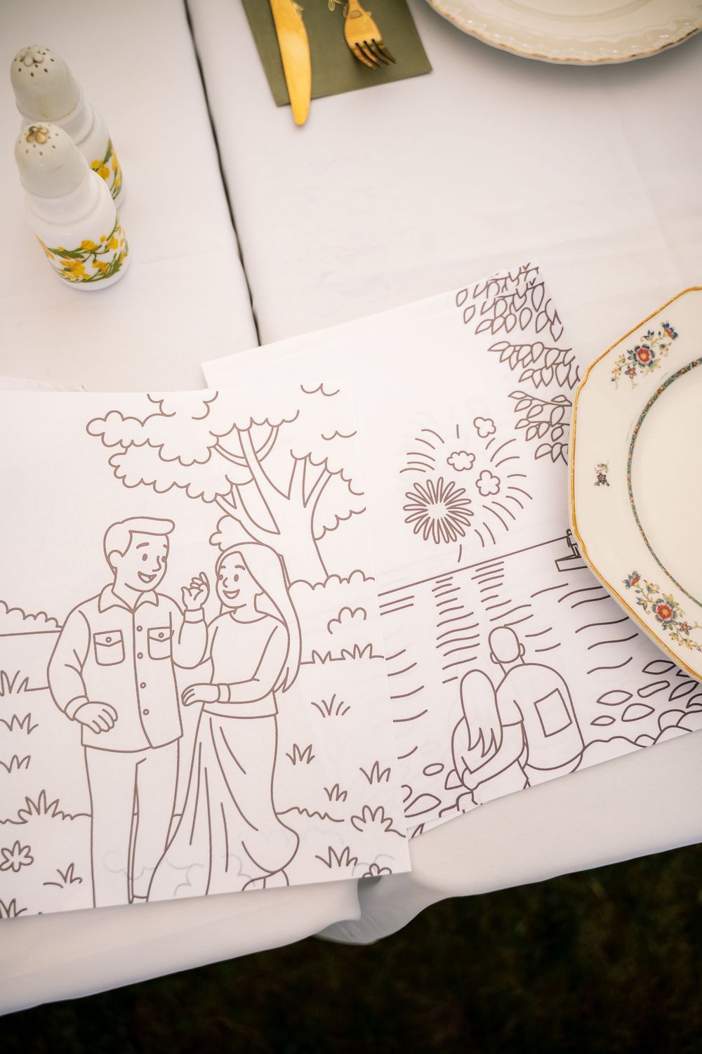 Simple line drawings tell a love story across multiple panels on white paper at wedding reception.