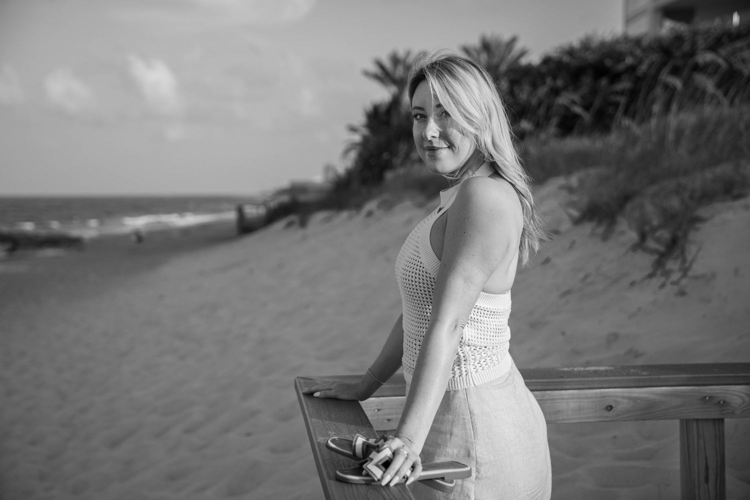Client on the boardwalk of coral cove beach, tequesta florida, during an individual photo shoot