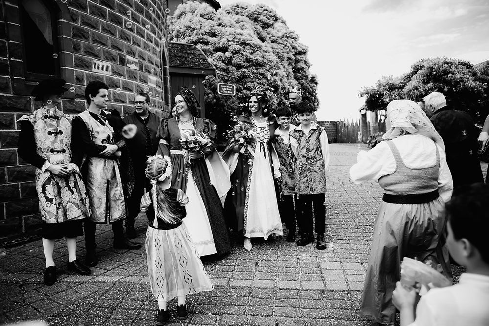 Black and white vintage photographs arranged in a row showing outdoor gatherings and celebrations.