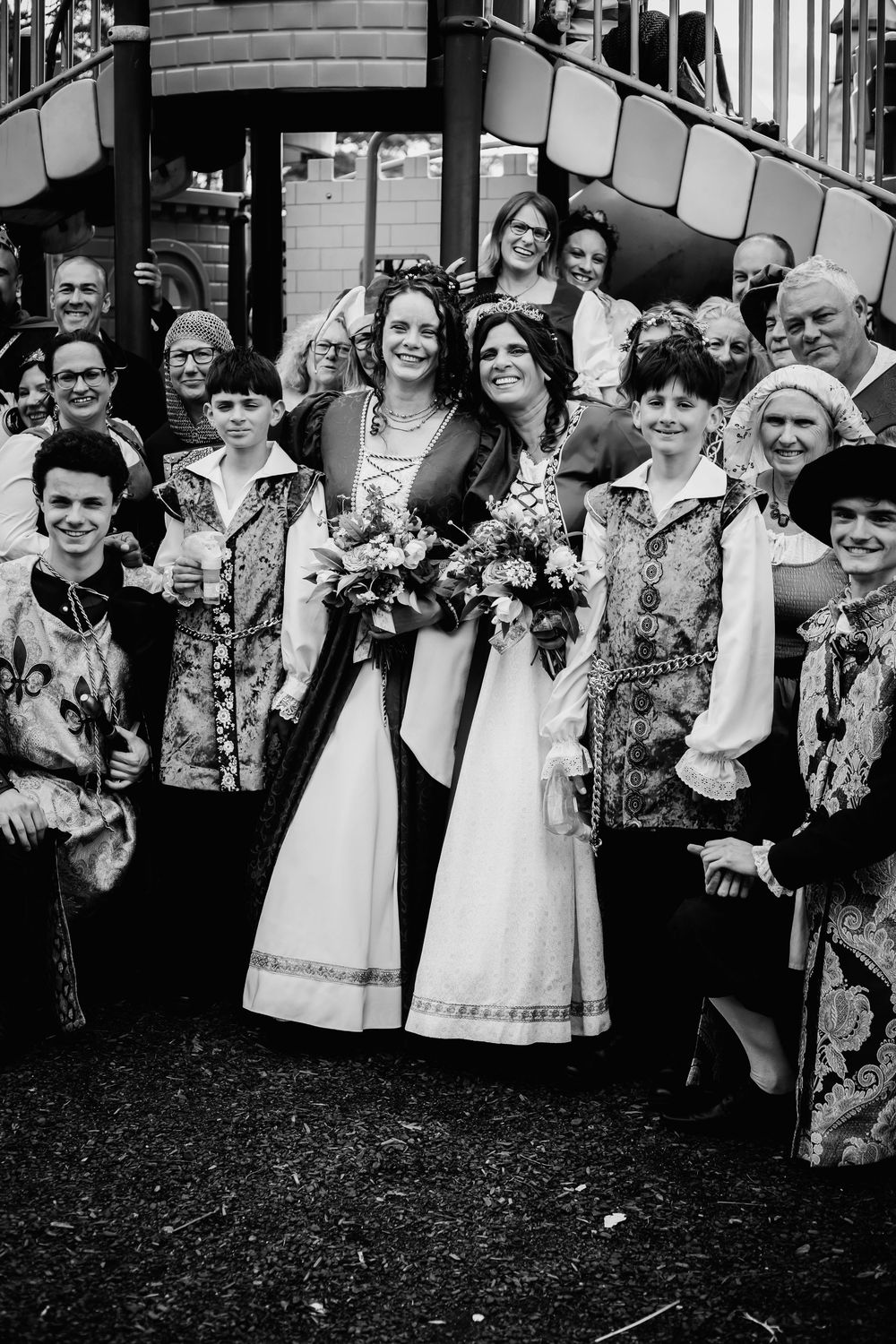A black and white wedding photo series showing a joyful bridal party posing with bouquets.