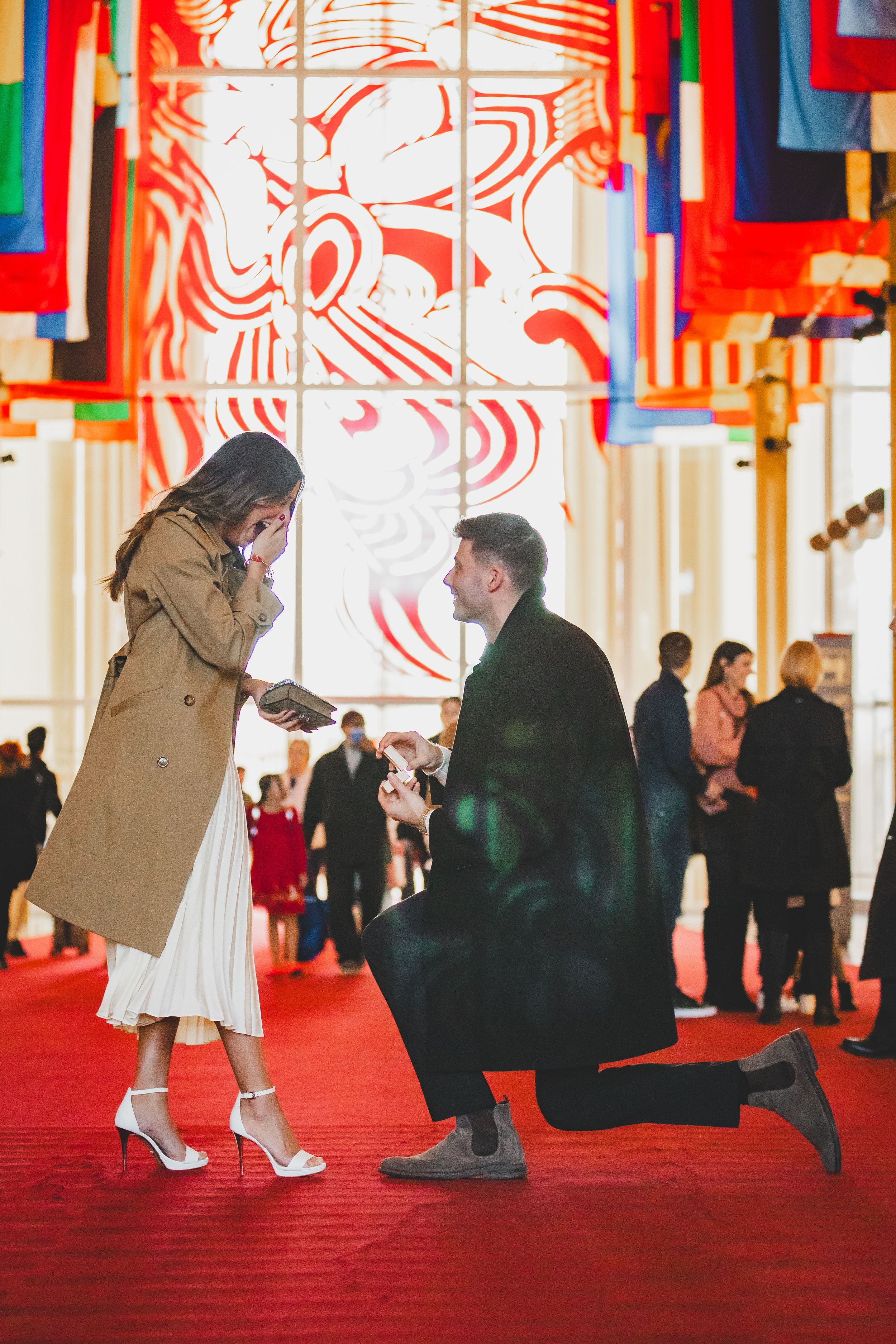 A man proposing in the great hall of The John F. Kennedy Performing Arts Center