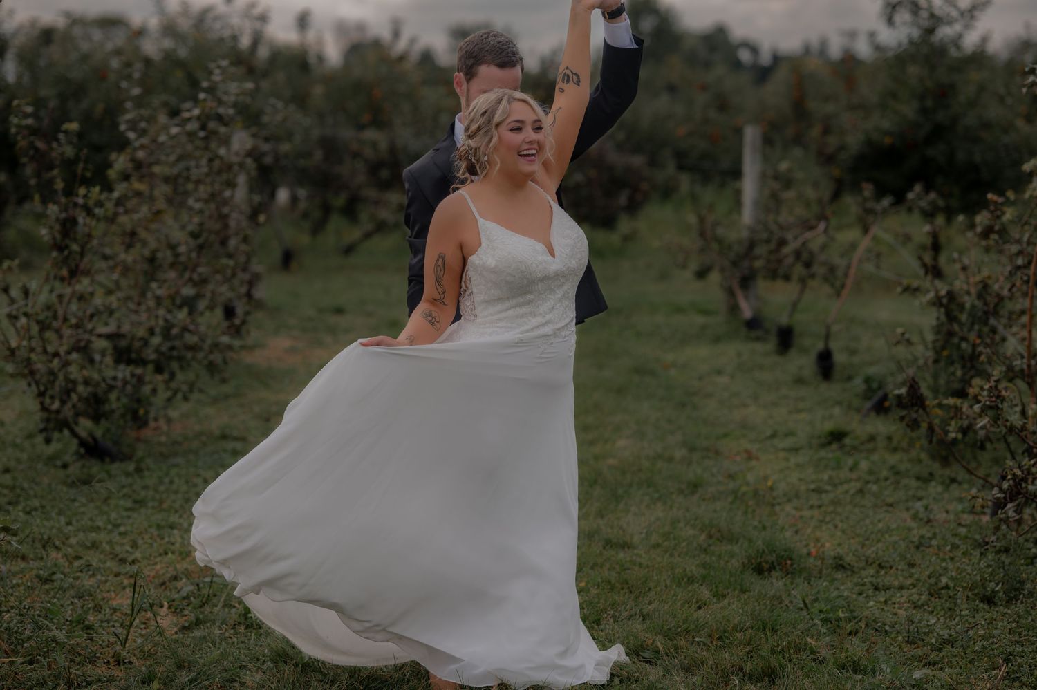 A series of romantic wedding photos showing a couple dancing and embracing in a rustic field at sunset.