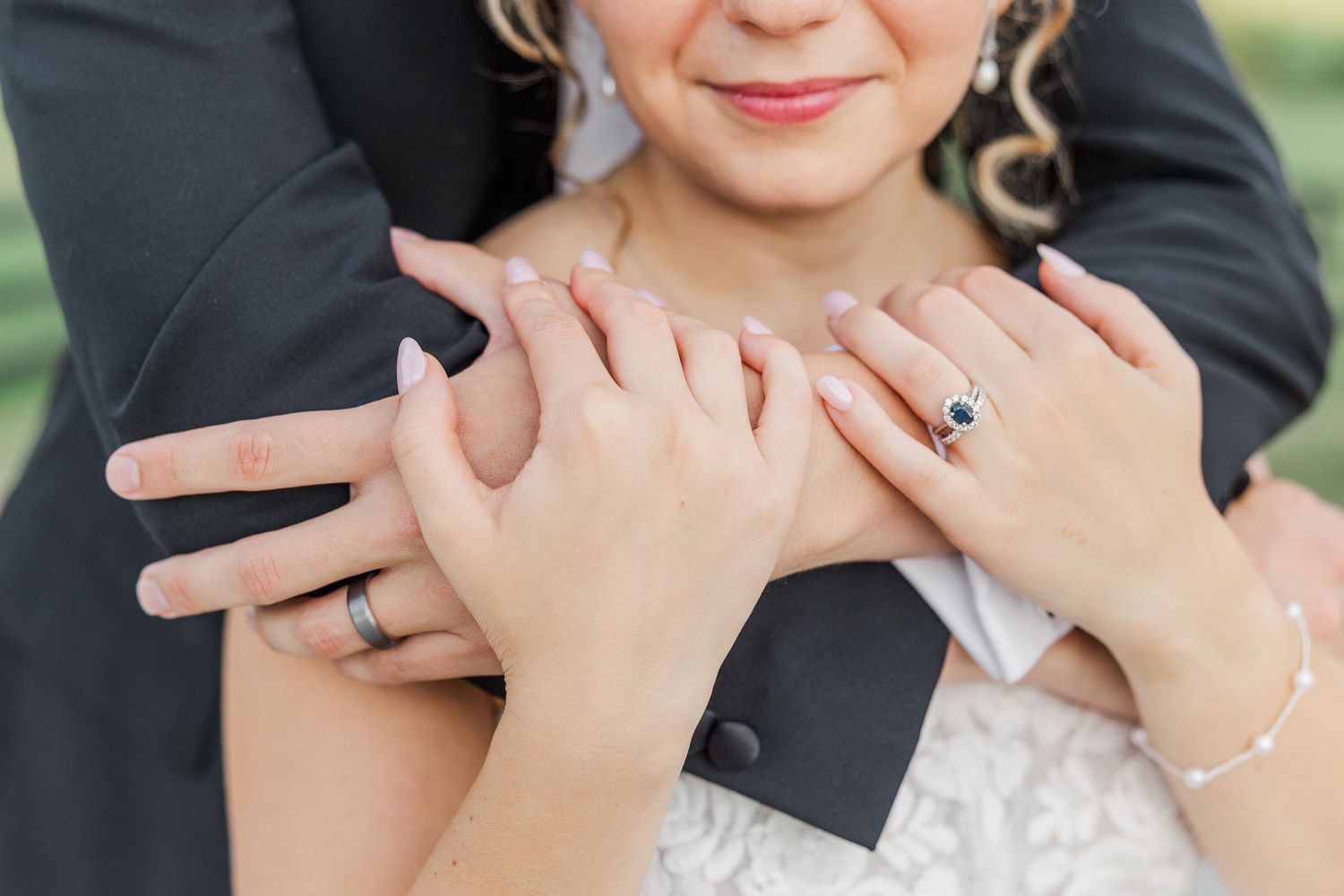 Close-up detail of hands embracing during an intimate wedding moment.