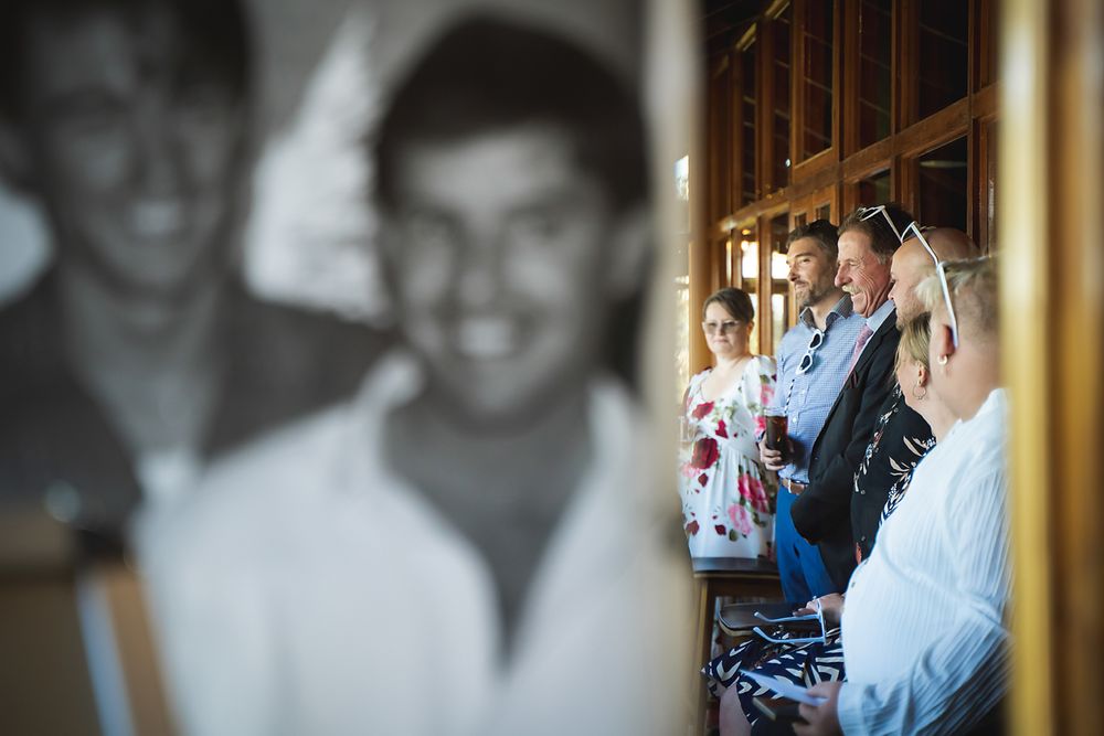 Black and white candid shots of guests socializing at an indoor gathering.
