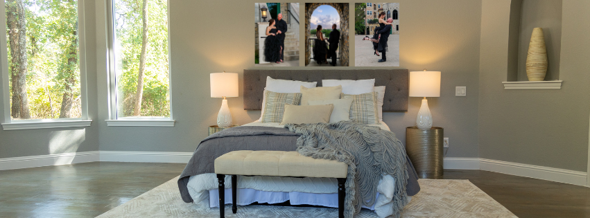 A series of framed photos displayed on a dark wall above a white cabinet with potted plants. Engagement and couple