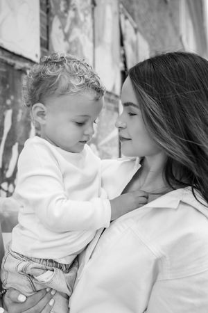 Intimate black and white portrait of mother and child sharing tender moment.