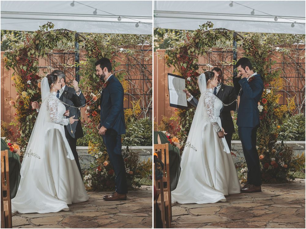 A couple shares a romantic first dance moment during their outdoor garden wedding ceremony.