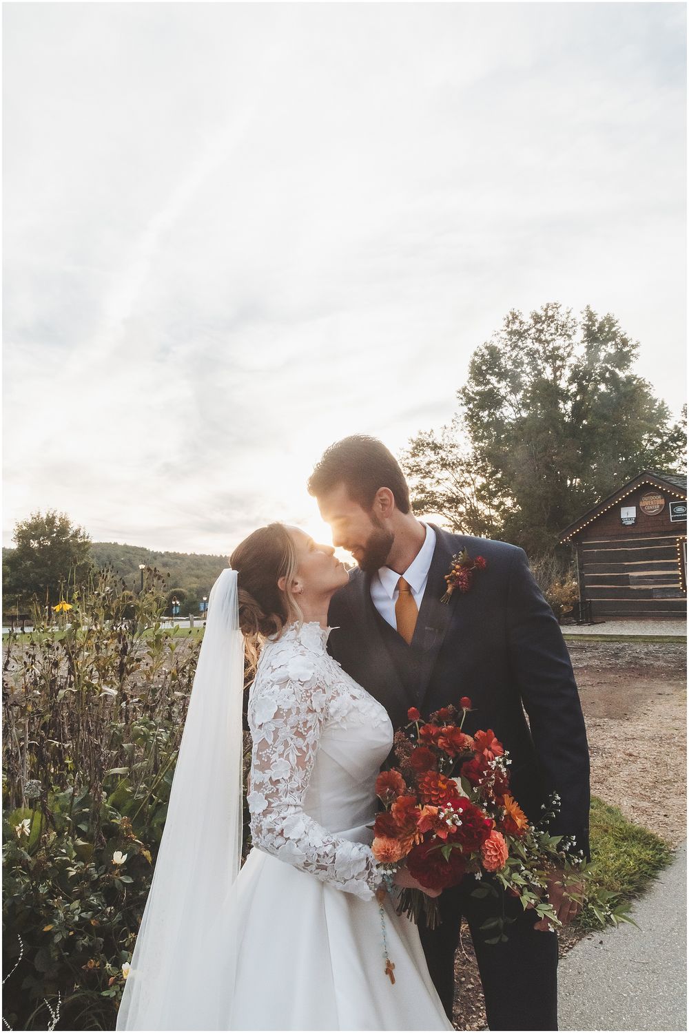 A romantic outdoor wedding photo sequence showing tender moments between newlyweds with a vibrant fall bouquet at sunset.