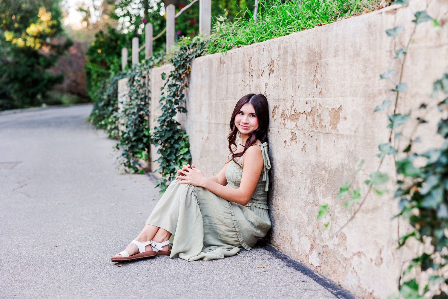 Romantic wedding photoshoot series showing details of dress, shoes and poses against stone wall and garden backdrop.