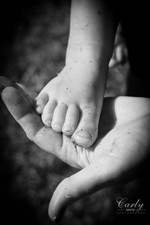 Black and white close-up photos showing tiny baby toes and feet in artistic detail.