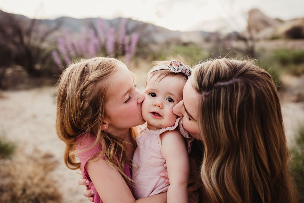 Intimate family photography session showing joyful moments in natural desert backdrop.