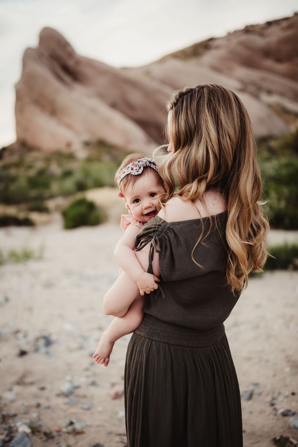 A collection of tender moments between parent and child against a rocky desert backdrop.