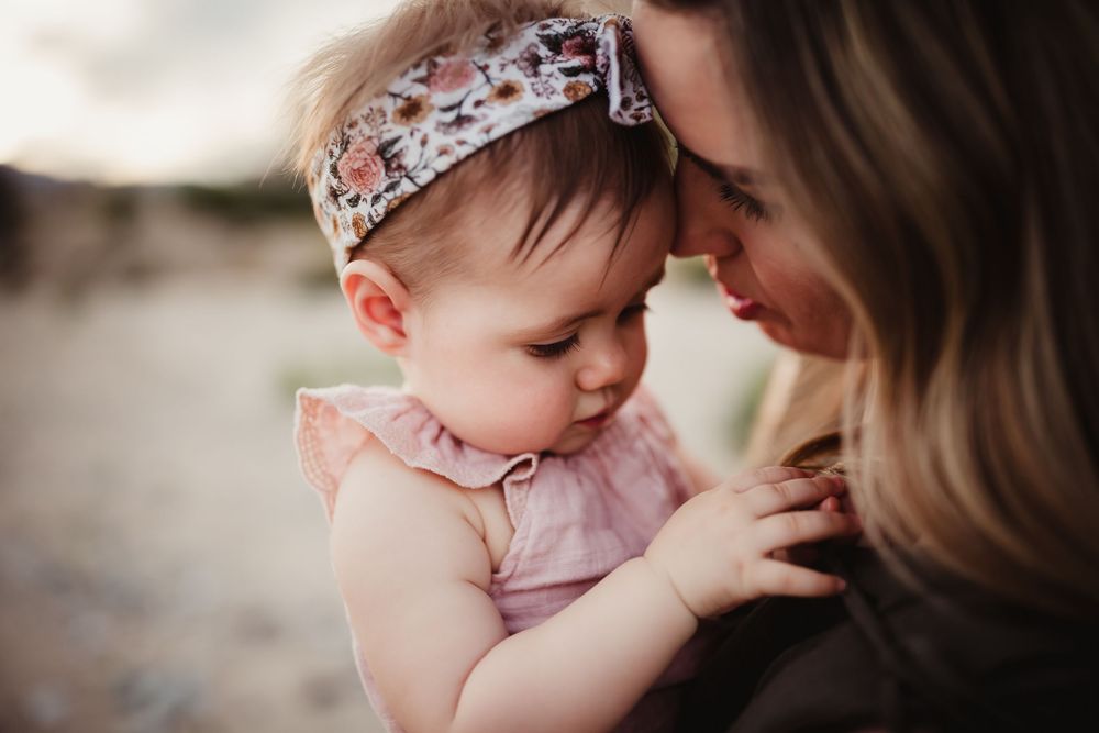 Close-up shots showing gentle interactions between family members in soft, natural lighting.