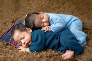 Sleeping twin newborn babies cuddled together during studio newborn photoshoot in Hyderabad