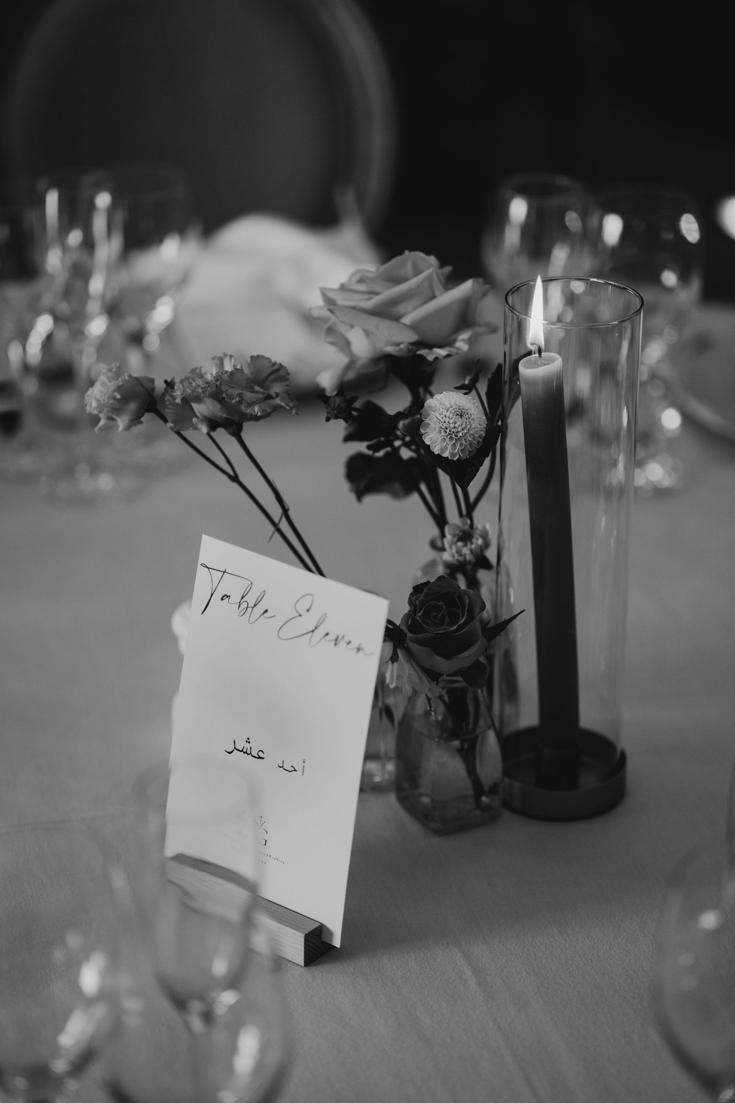 Black and white table settings with name cards and floral centerpieces create an elegant dining atmosphere.