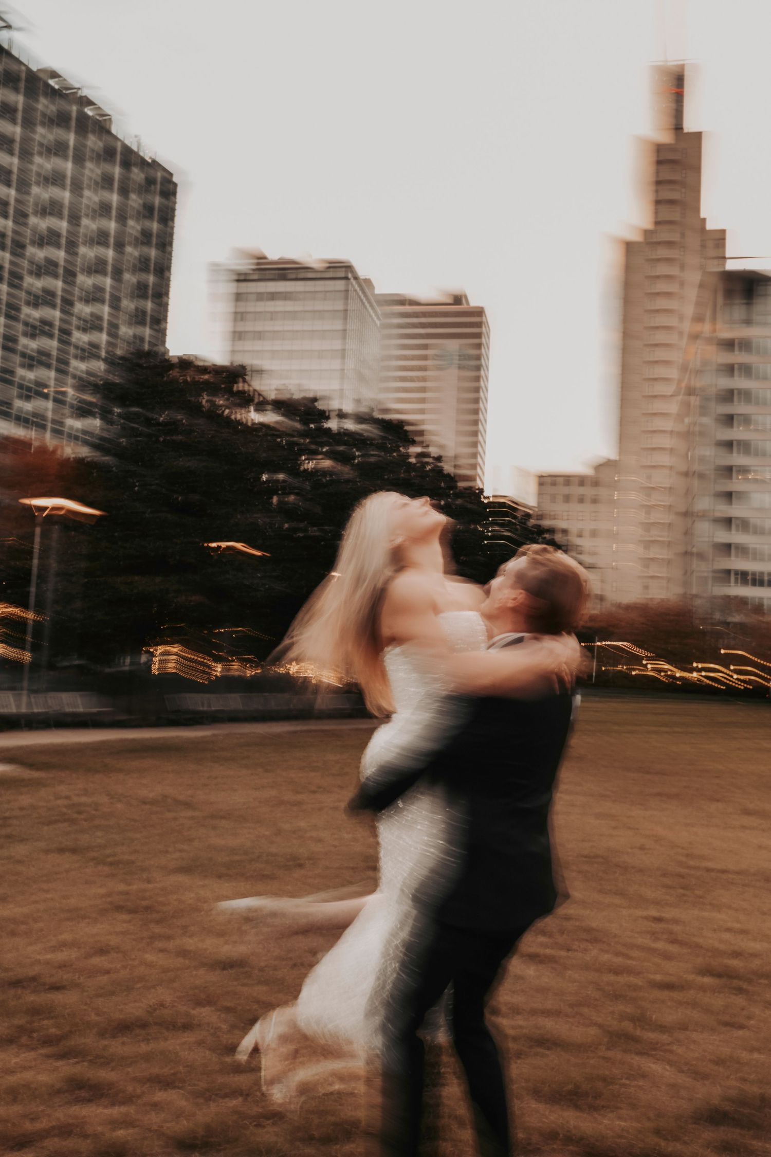 Cinematic engagement photos of couple walking through Dallas arts district streets