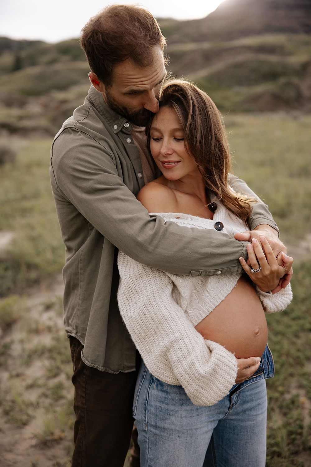 Intimate maternity photo of a couple embracing outdoors in calgary alberta