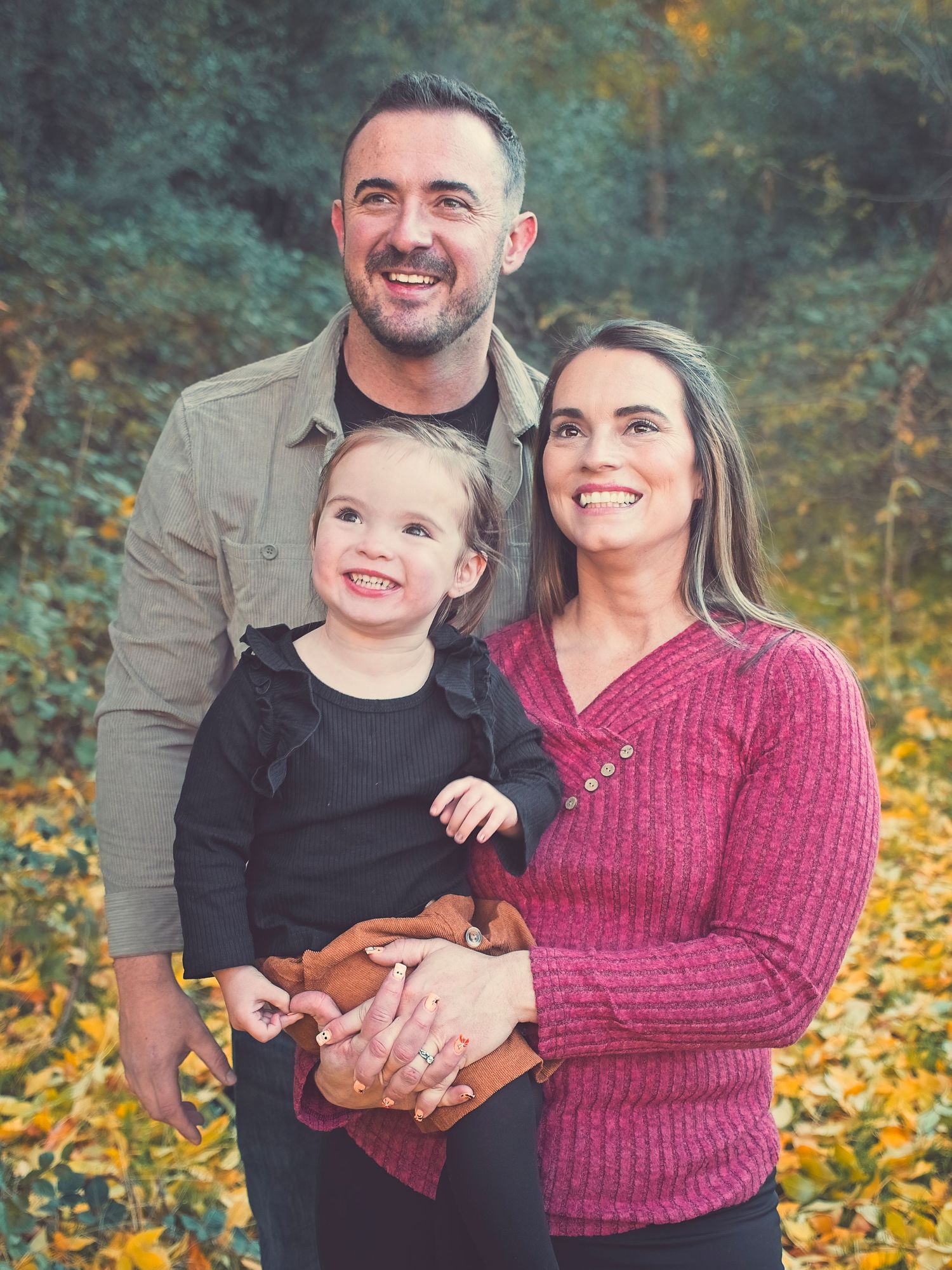 Family portrait of a father, mother, and young girl
