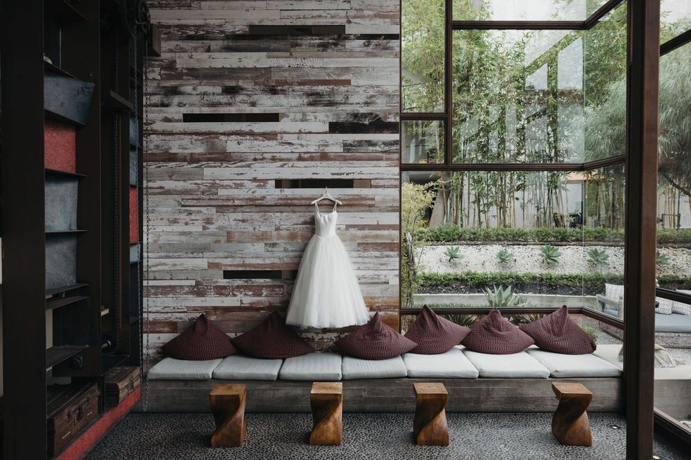 Modern rustic wedding venue interior with weathered wood walls and large windows overlooking nature.