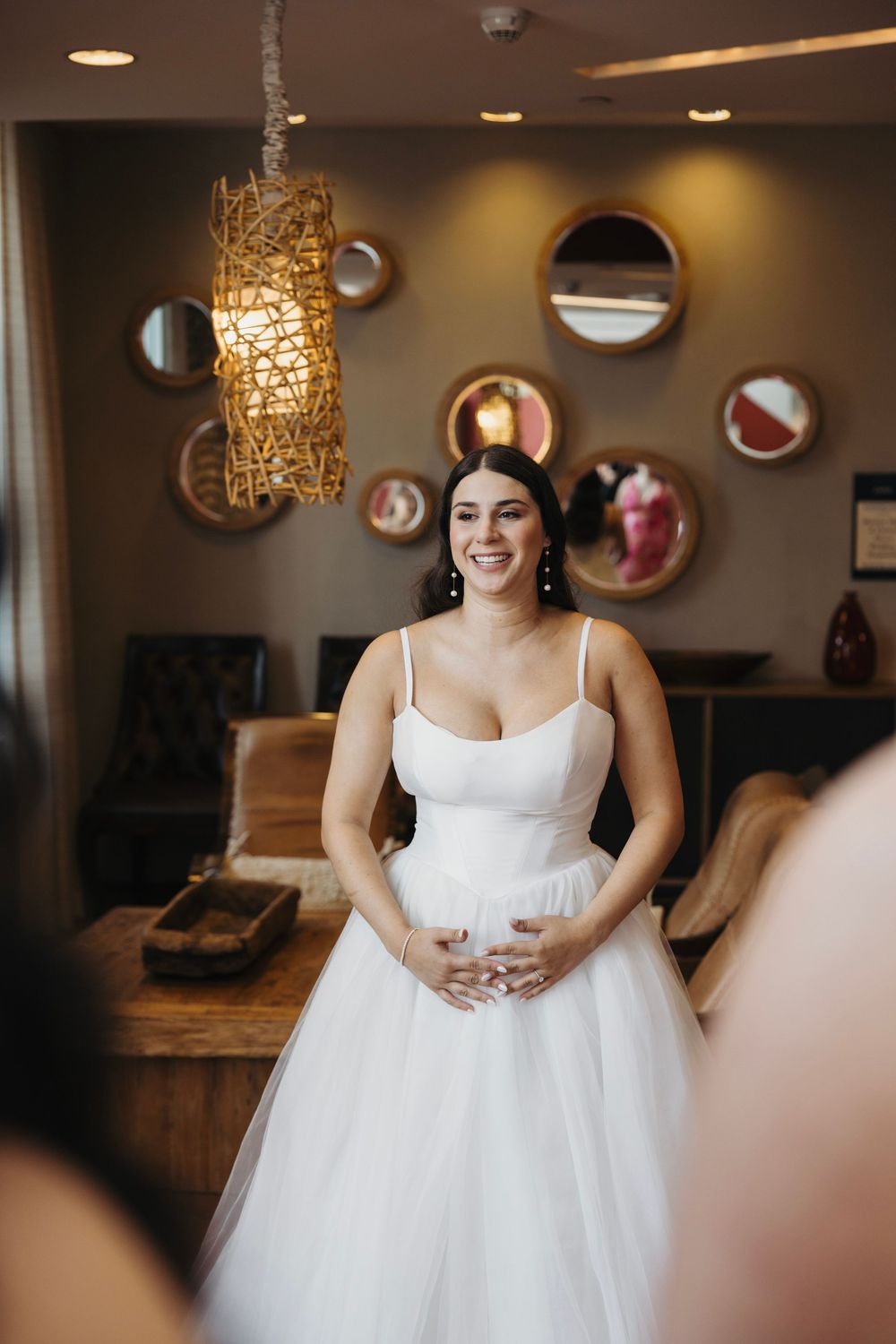 Modern wedding venue interior with decorative circular mirrors and warm lighting.