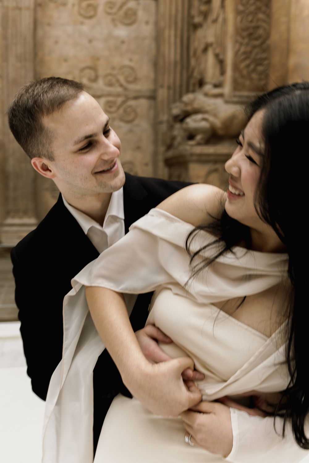 A romantic series of close-up shots showing a couple in an intimate embrace against an ornate architectural backdrop.
