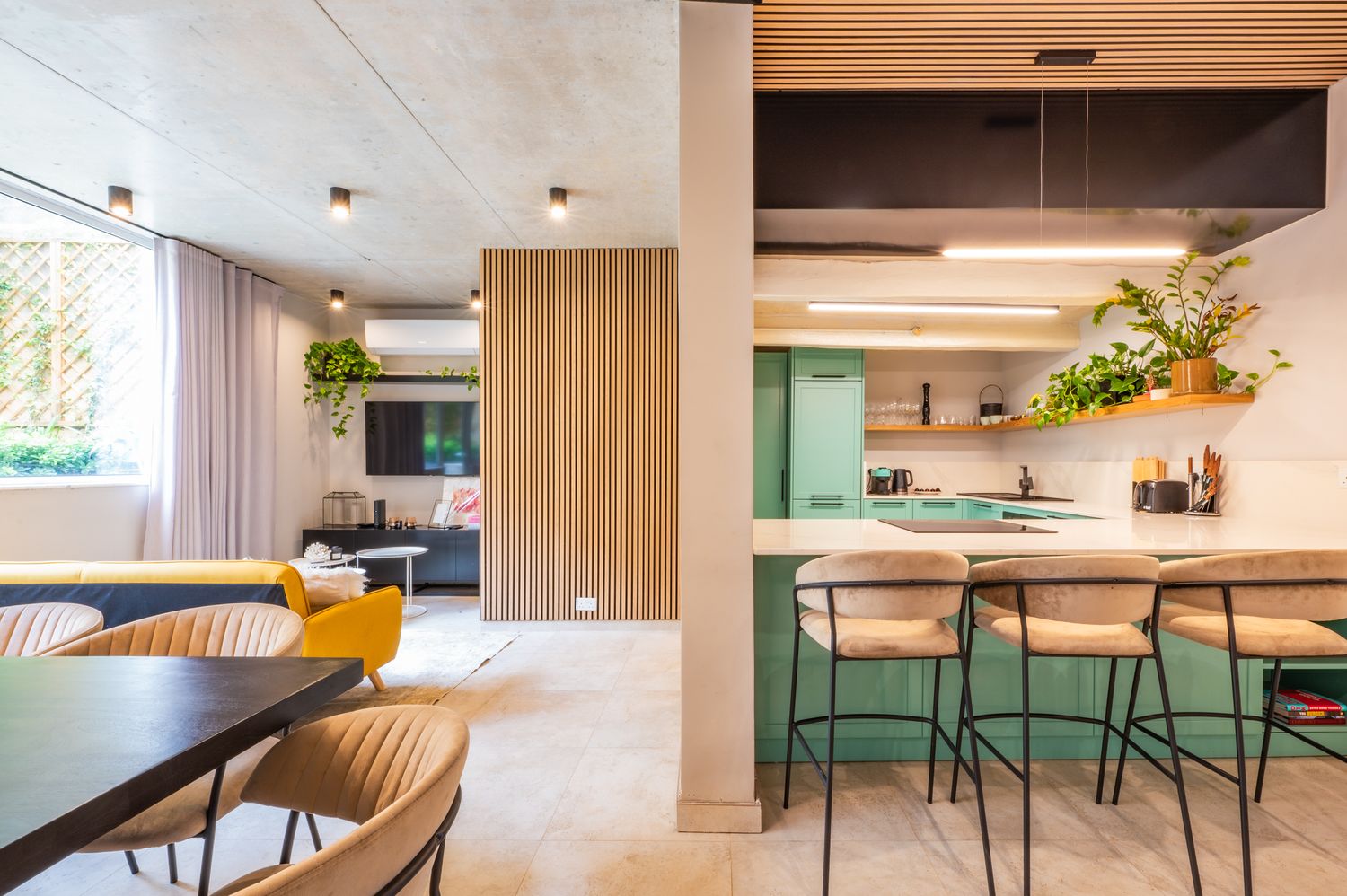 Modern restaurant interior with wooden ceiling panels and minimalist design elements.